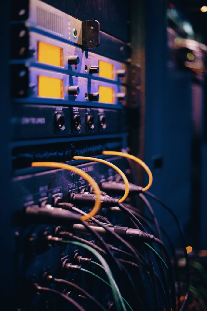 Cables plugged into a rack of network equipment